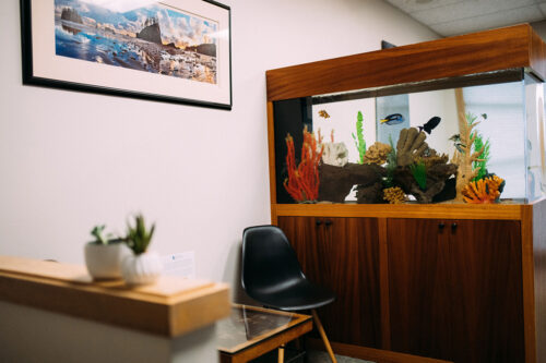 Chair and table set up in the waiting room of dental practice office in Burien, WA