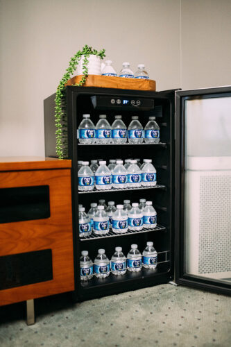 Refrigerator stocked with bottled water in the waiting area of a dental practice in Burien, WA