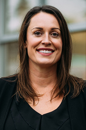 Female dental hygienist in Burien, WA standing outside dental office