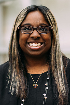 Female patient care coordinator in Burien, WA standing outside dental office