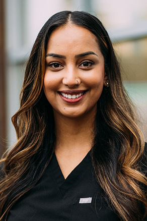 Female dental hygienist in Burien, WA standing outside dental office